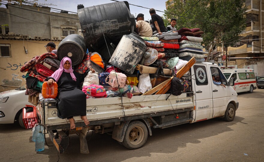 Palestinians pile their belongings on a vehicle as it drives to safer areas in Rafah, in the southern Gaza Strip, on Friday.