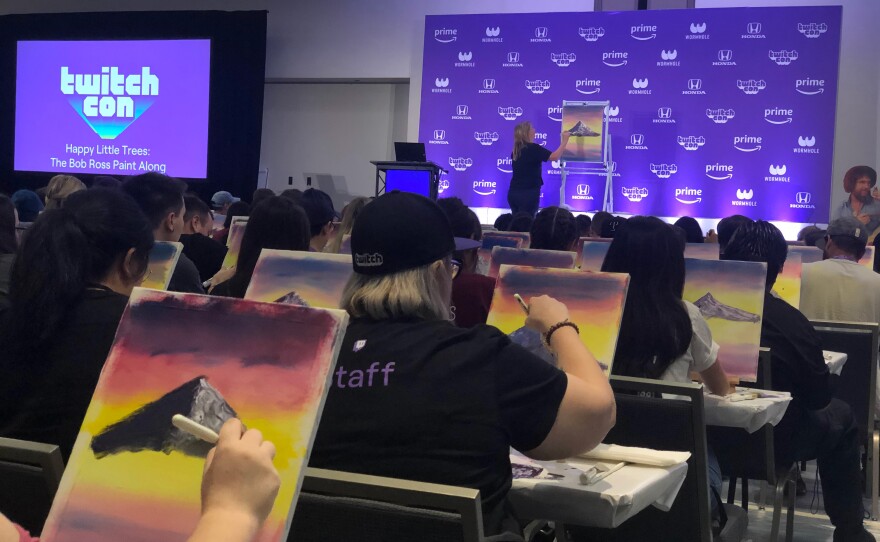Certified Ross Instructor (CRI) Fay Dasher leads a Bob Ross Paint-Along at TwitchCon in September 2019.