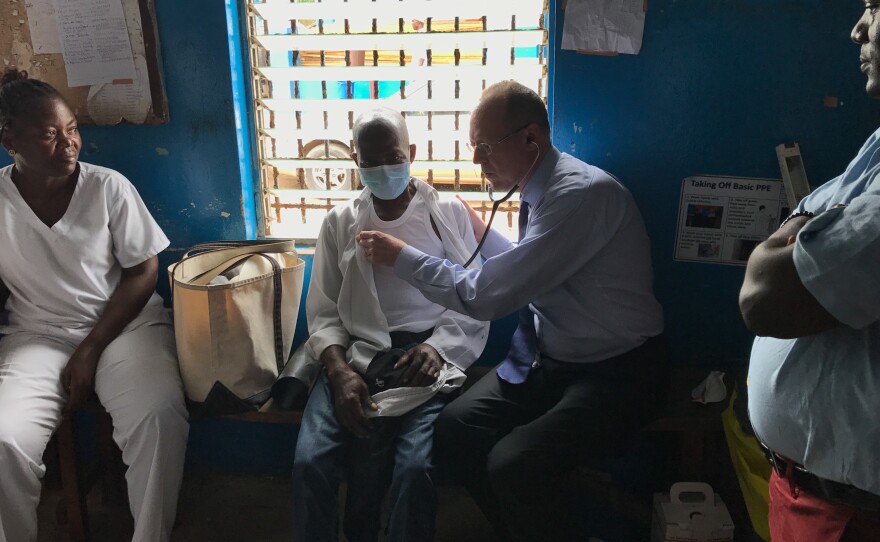 Dr. Paul Farmer examines a tuberculosis patient in Monrovia, Liberia.