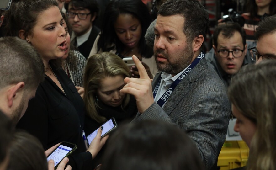 Chaos reigned in Des Moines, Iowa, on Feb. 3, 2020, as reporters pressed various campaign and election officials for why the caucus results were so delayed.