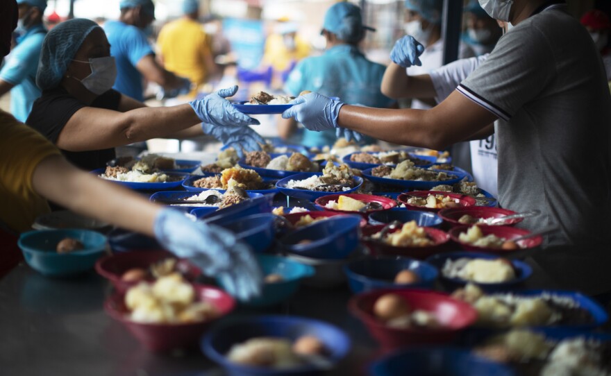 The plates are full of beans and rice, potatoes, eggs and tuna.