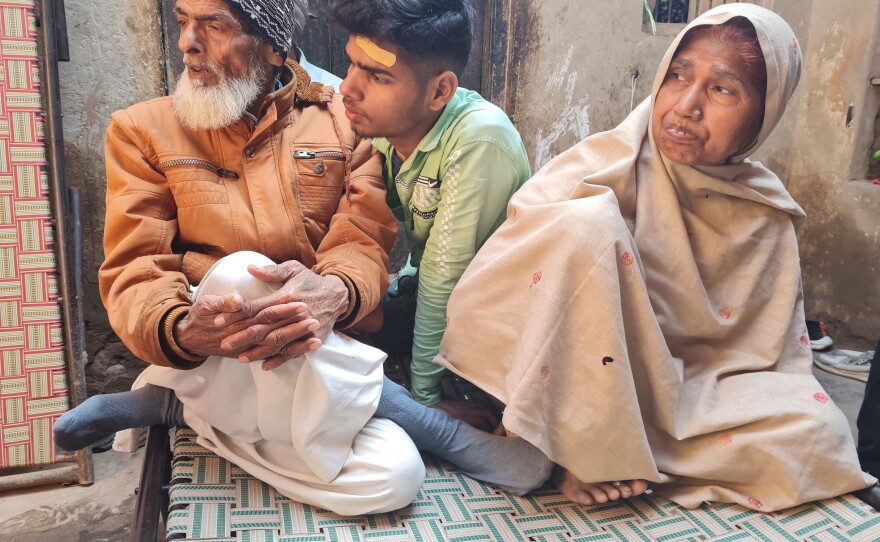 Mohammad Ayan, Faisal Husain's brother, sits between parents Islam Husain and Naseema Bano. Ayan wants to study law. "I want to fight for justice for cases similar to my brother's," he says.