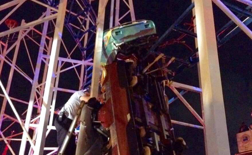 "Firefighters working as fast as they can to rescue 2 riders that are in a dangling rollercoaster car," the Daytona Beach Fire Department tweeted late Thursday.