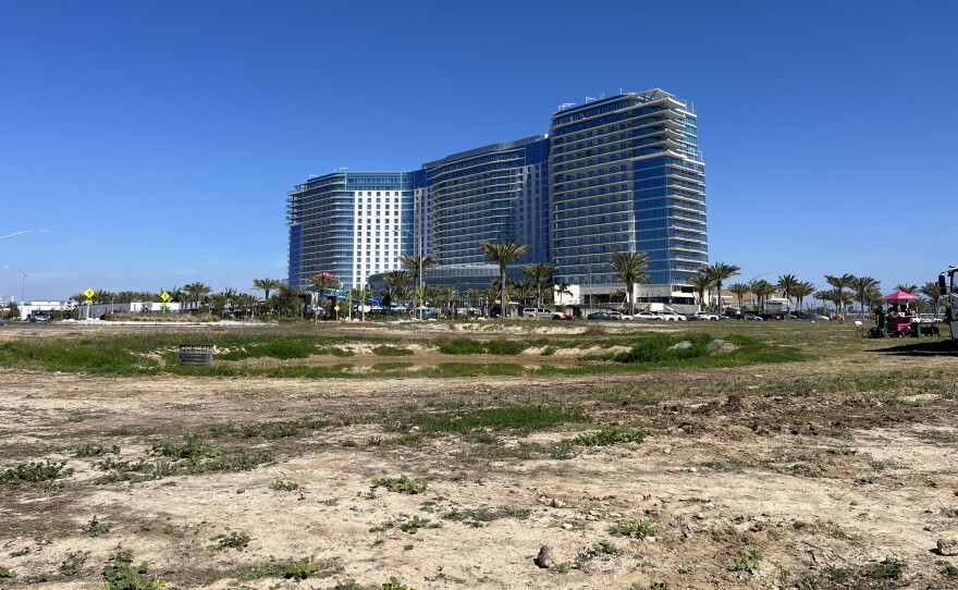 A dirt lot with small grasses will soon be constructed into Harbor Park, March 3, 2026.