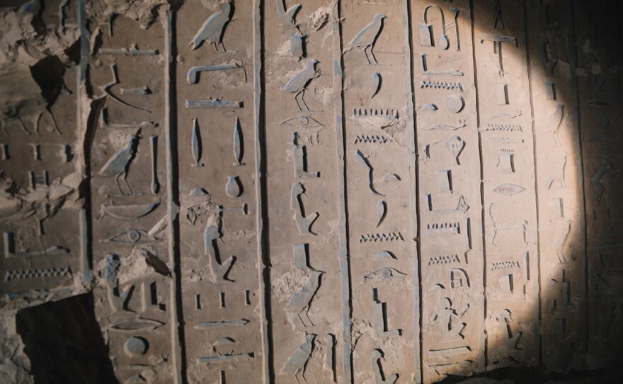 Hieroglyphics illuminated by flashlight in Theban Tomb 33, known as “TT33,” at the Theban Necropolis in Upper Egypt. TT33 belongs to royal scribe and priest Padiamenope, and is the largest non-royal tomb in the country.