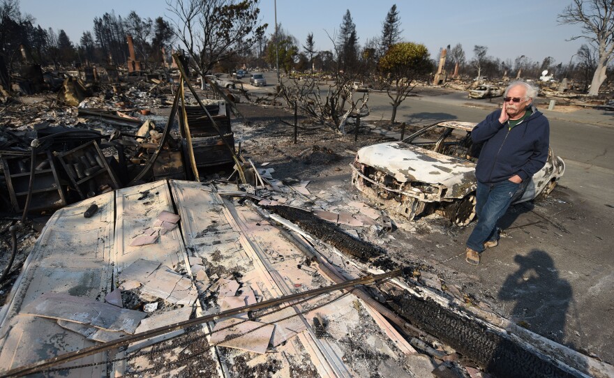 Homeowner Phil Rush is confronted by the remains of his home that was destroyed by wildfire in Santa Rosa, Calif. He says he and his wife and dog escaped with only their medication and a bag of dog food when flames overtook their entire neighborhood.