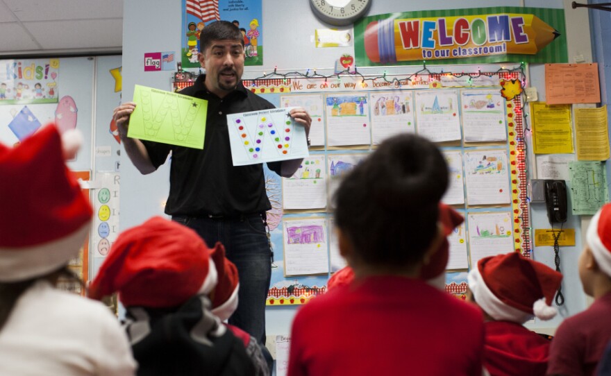 Hugo Villavicencio talks to kindergarten students at Lenicia B. Weemes Elementary School about the importance of attending school.