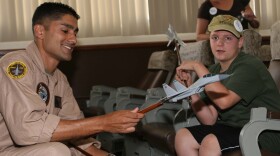 Maj. Taj Sareen - then a captain in this 2009 photo - shows Jared Hyams the model fighter jets pilots use during briefs. The Make-A-Wish foundation granted Hyams his wish to attend the 2009 Marine Corps Air Station Miramar Air Show.