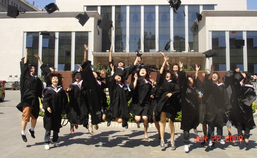 The author's classmates celebrate during graduation at Minzu University of China in Beijing, China, in June 2009.