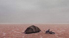 Lake Eyre and its salt flats in South Australia. In this photo you can see photographer Murray Fredericks' small tent and bike used on his solo camping trips.