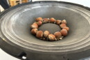 Hazelnuts bounce on a speaker at “Ess Whiteley: listening materials” at the Athenaeum Art Center in Logan Heights on Aug. 25, 2026.