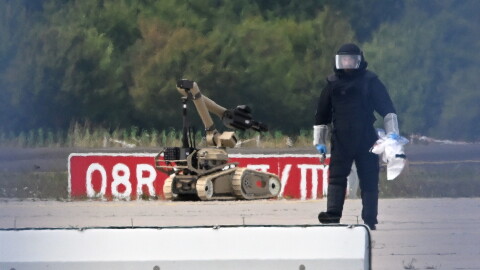 A forensic technician works alongside a bomb-disposal robot near a Ukrainian aircraft at Leipzig/Halle Airport, where a drone with an explosive device was found and a detonator was removed from the object, in Schkeuditz, Germany, Wednesday Aug. 5, 2026.