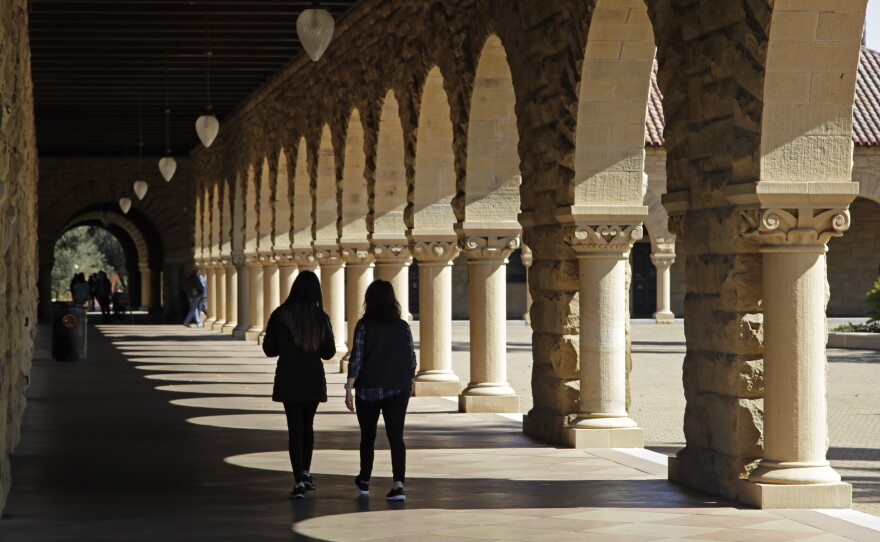 Students walk on the Stanford University campus on March 14, 2019, in Stanford, Calif.
