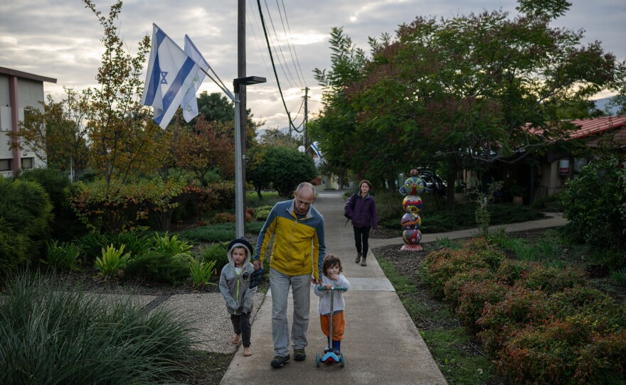 Yoav Rotem, his wife Michal Inerman and their children Sahar Inerman, 2, and Harel Inerman, 7, walk through Kfar Szold, a kibbutz in northern Israel near the border with Lebanon, on Nov. 28.