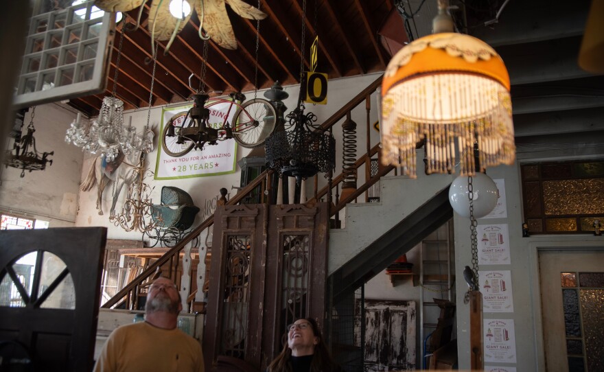 Elizabeth Scalice is shown looking up at items hanging from the ceiling at Architectural Salvage on Jan. 11, 2024.