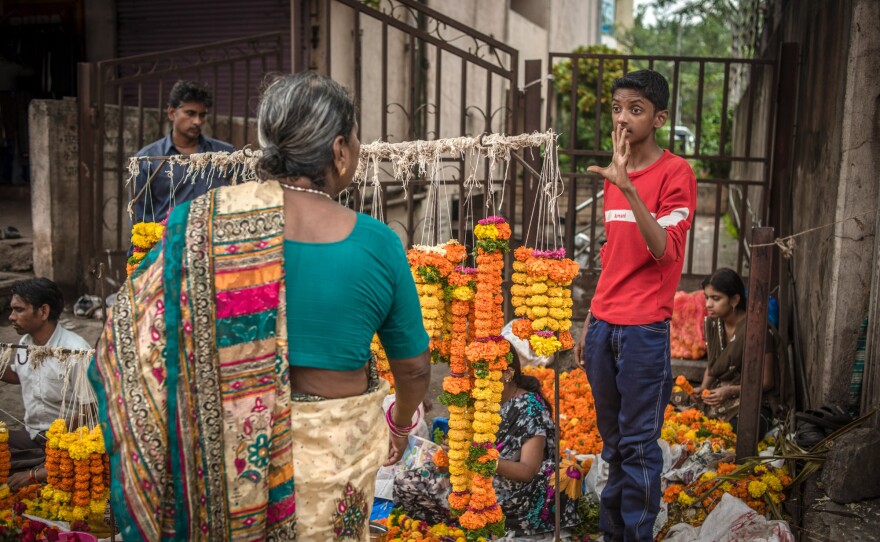 Aniket's favorite part of the day is selling flowers at a street market after school.