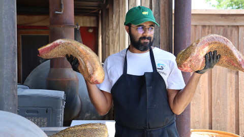 Zain Shafi prepares to put briskets in the smoker at Goldee's BBQ in Fort Worth, Texas.