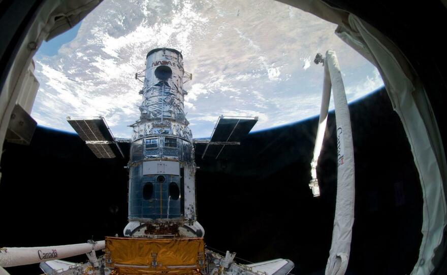 The Hubble Space Telescope in 2009, locked in a space shuttle's cargo bay, before the final repair work ever done.