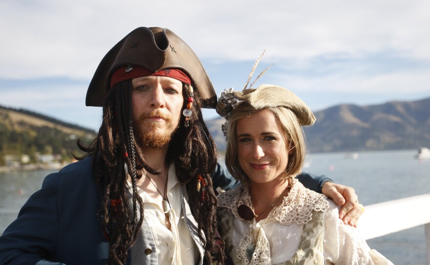 Bridegroom Toby Ricketts and bride Marianna Fenn stand on a jetty in Akaroa harbor, New Zealand, on Saturday.