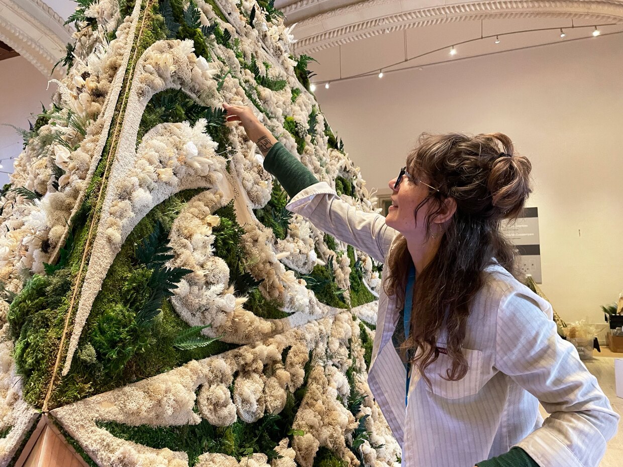 Artist Britton Neubacher works on her moss-covered large scale installation sculpture.