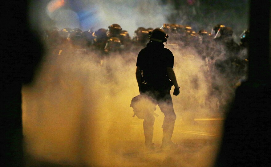 Police fire tear gas on Wednesday as protesters converge on downtown Charlotte, N.C. Two nights of unrest followed the fatal police shooting of Keith Lamont Scott on Tuesday.
