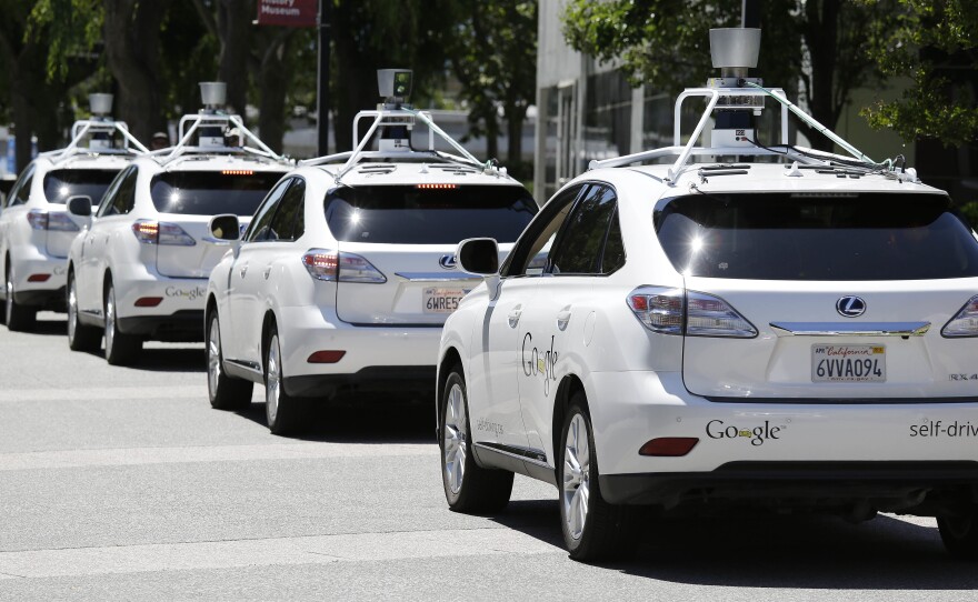 Google self-driving cars are shown outside the Computer History Museum in Mountain View, Calif., in May 2014.