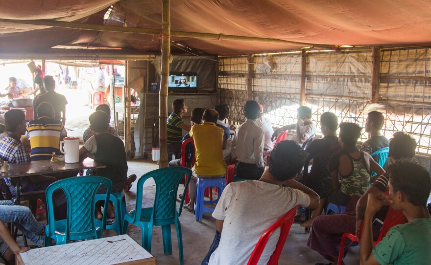Men watch a Hindi action movie on a TV in the Police Station Restaurant in the Balukhali 2 Rohingya refugee camp.
