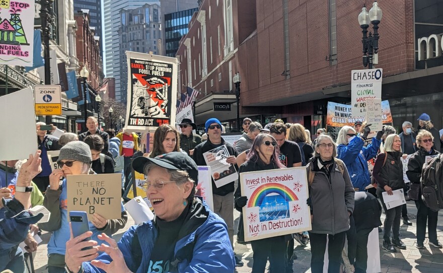 Climate activists in Boston gathered in front of a Chase Bank and marched to a Bank of America branch as part of a nationwide effort to urge banks to stop investing in fossil fuel projects.