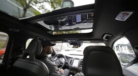 Devin Greene sits in the front seat of an Uber driverless car during a test drive in San Francisco,  Dec. 13, 2016. 