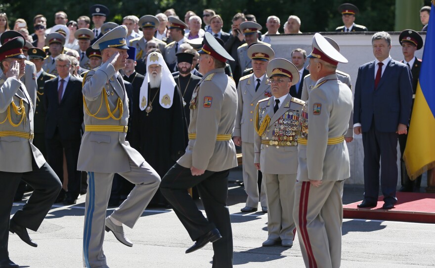 Ukrainian President Petro Poroshenko, far right, attends a graduation ceremony at the National University of Defense of Ukraine in Kiev Wednesday. In a speech there, the president said he is ordering a ceasefire in the struggle against armed militants.