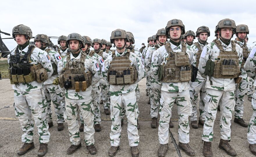 French army personnel stand during an official welcoming ceremony for the French Defense Minister at an air base in Romania on March 6.