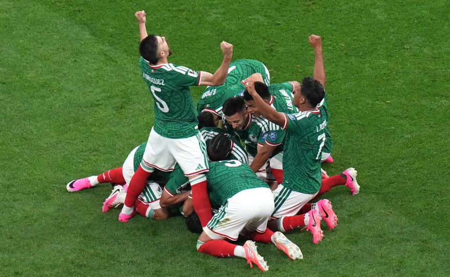 Mexico's Raul Jimenez (9) celebrates with teammates after scoring their second goal during the World Cup round of 32 soccer match between Mexico and Ecuador in Mexico City, Tuesday, June 30, 2026.