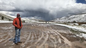 Rancher and Water Engineer Chad Espenscheid stand at an overlook of his property on the Middle Piney Creek with a snowstorm brewing behind him in this undated photo. 