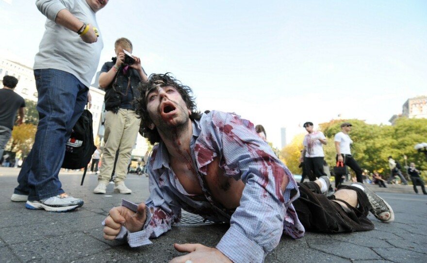 A zombie crawls through New York's Union Square during a promotion for the AMC network television series  <em>The Walking Dead.</em>