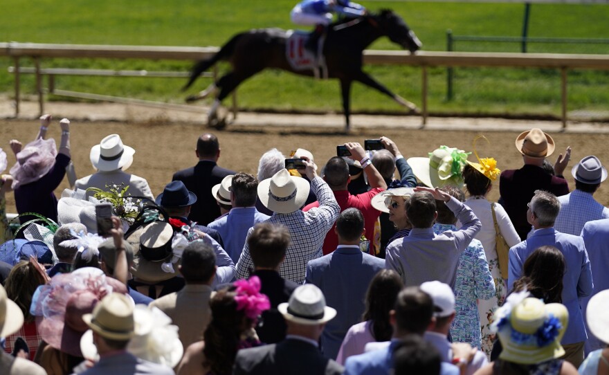 Fans cheers during race five before the 147th running of the Kentucky Derby at Churchill Downs in Louisville, Ky.