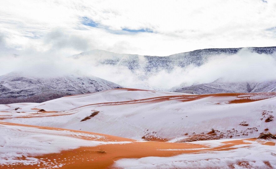 A scene of snow, striped in orange: This is how the desert surrounding Ain Sefra in Algeria appeared to residents for a few fleeting hours Sunday.