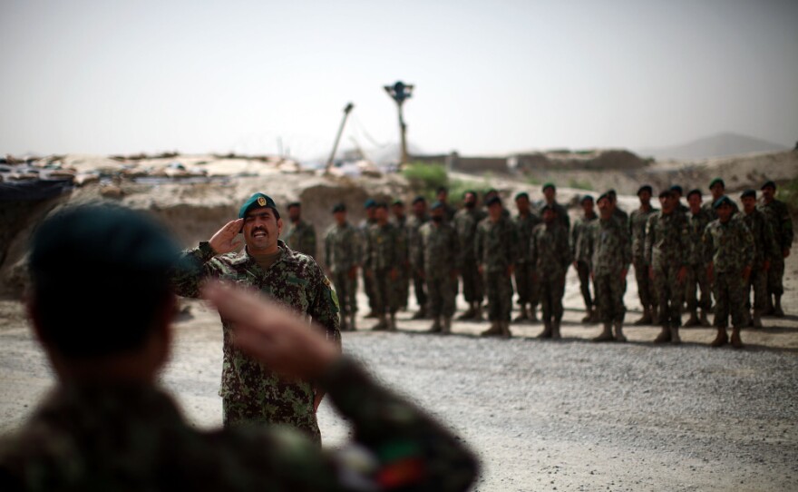 Brig. Gen. Ahmed Habbibi of the Afghan National Army salutes his soldiers in Panjwai district near Kandahar in southern Afghanistan.