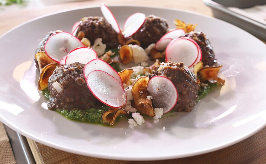 Goat meatballs with garlic mustard, pesto, local feta and sunchoke chips from Chef Matt Louis.