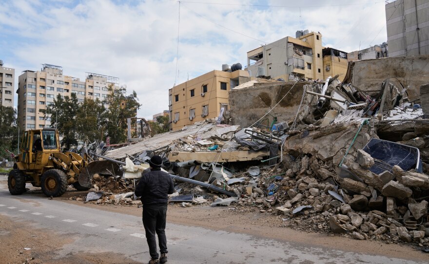 A bulldozer clears debris from the rubble of buildings destroyed in an Israeli airstrike, in Dahiyeh, Beirut's southern suburbs, Lebanon, Monday.