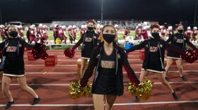 El Modena High School cheerleaders perform during the school's football game with El Dorado High School in Orange, Calif., Friday, March 19, 2021. 