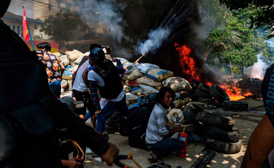Smoke rises from burning tires on Saturday as demonstrators gather in Thakeyta Township, Yangon, to continue their protest against the military coup in Myanmar.