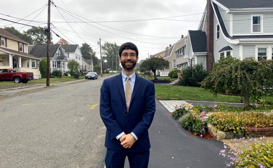Andrew Mikula is a housing economist leading the push for smaller lot sizes. He stands on an older block in North Braintree, Mass., with smaller lots that would be illegal for new homes today.