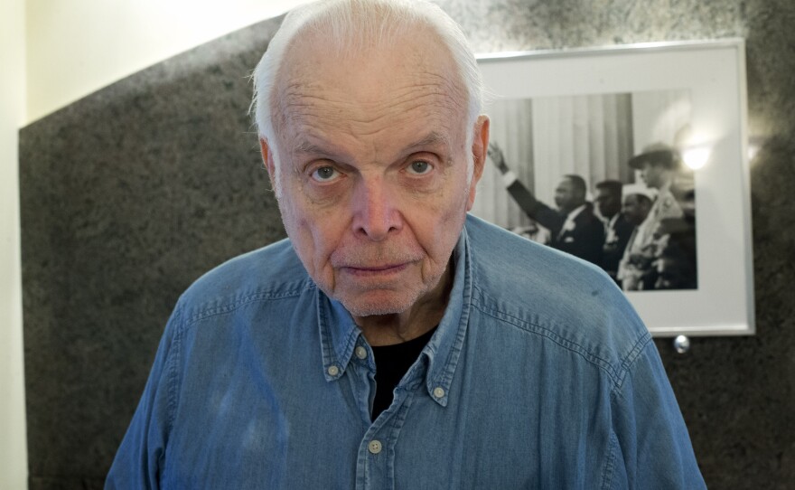 Bob Adelman stands in front of a photo of Martin Luther King he made during his days covering the civil rights movement.