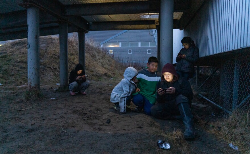 Kids hang out near the school in Akiak, Alaska to access wireless internet through their phones.