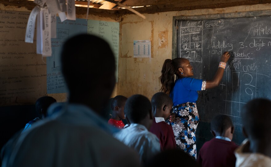 The third-grade teacher, Florence Lerapayo, teaches a math lesson. She says when Paris first arrived in her classroom he seemed uneasy and adrift.
