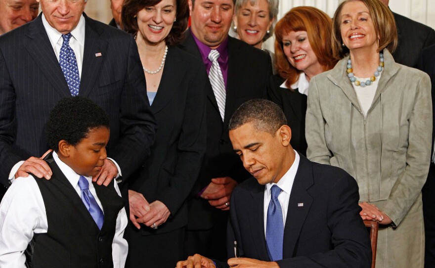 President Obama signs the Affordable Care Act at the White House on March 23, 2010.