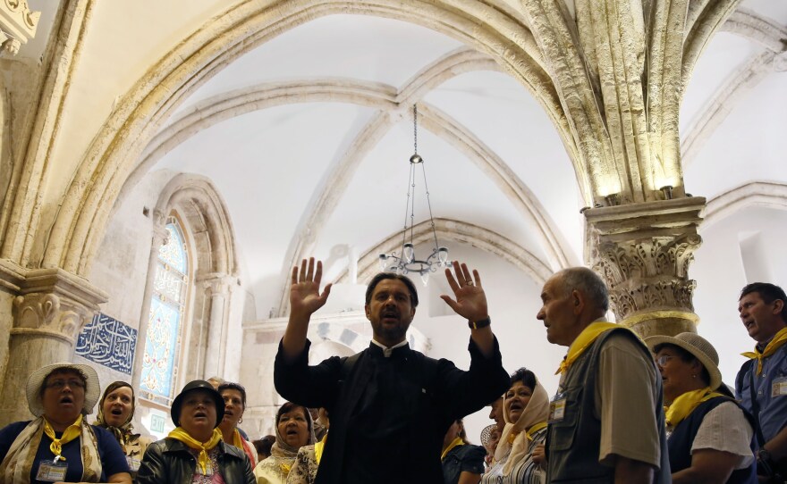Christian pilgrims from Romania pray at the Cenacle, or Upper Room, on Mount Zion in Jerusalem on May 19. The hotly contested site is holy to Christians, Jews and Muslims, and is where Pope Francis will celebrate Mass on Monday.