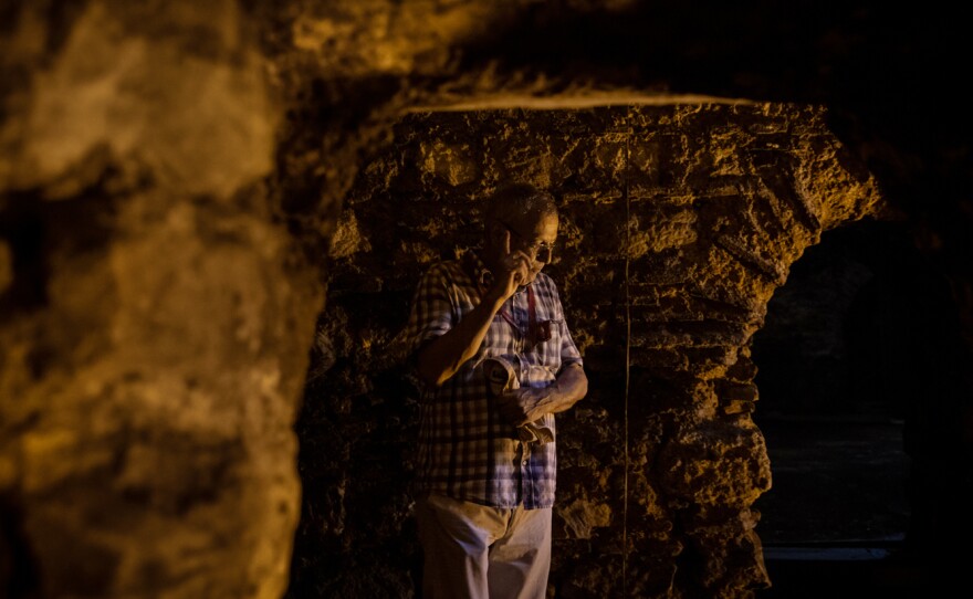 Left: Remnants of pottery and glass are seen among restored Byzantine-era ruins in a basement below a carpet shop. Right: Ozgumus stands in a substructure with mason work he believes dates back to the 4th to 6th centuries. Due to its location and layout, he suggests it may have been a substructure that was part of the palace complex built by Constantine the Great.