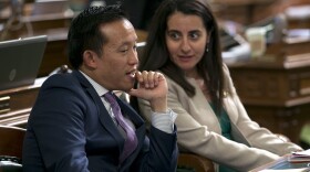 Assemblyman David Chiu, D-San Francisco talks with his seat mate, Assemblywoman Monique Limon, D-Goleta, after the Assembly approved Chiu's immigration bill in Sacramento, Calif. , Monday, Sept. 11, 2017. 