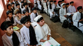 Afghan school boys wear Taliban-imposed uniforms of turbans and long tunics in a school in Herat. The government has put more focus on religious education since returning to power on August 15, 2021.